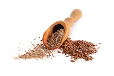 Tahta kepçeyle keten unu ve beyaz arka planda tohumlar