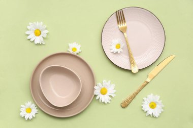 Yeşil arka planda güzel kasımpatı çiçekleri olan şık bir masa.