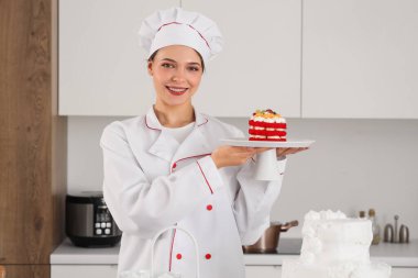 Mutfakta lezzetli pastası olan bir kadın pastacı.