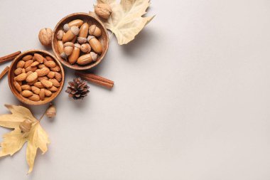 Gri arka planda meşe palamudu, fındık, tarçın çubuğu ve düşen yapraklı kompozisyon