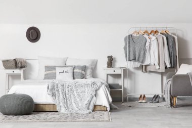 Giysilerle, komodinlerle ve yatak odasının içinde rahat bir yatakla dizilin.