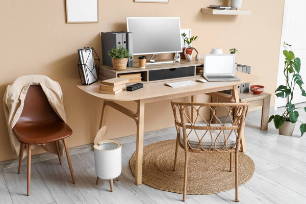 Comfortable workplace with modern computer and laptop