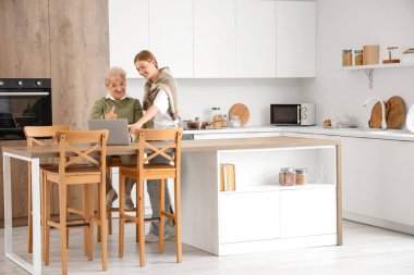 Evde dizüstü bilgisayarı olan mutlu bir son sınıf öğrencisi ve torunu var.