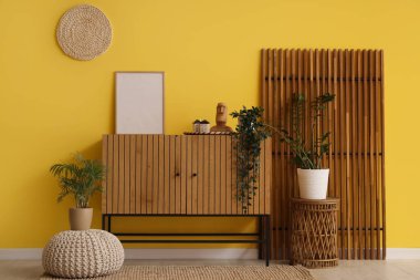 Oturma odasının içi ahşap tuvalet, katlanır ekran ve boş çerçeve.