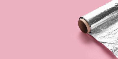 Aluminium foil roll on pink background with space for text, closeup clipart