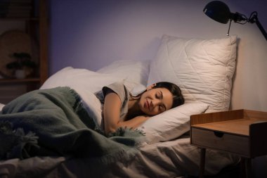 Güzel, genç, mutlu bir kadın. Akşamları yatağında uyuyor.