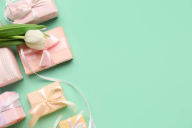 Turkuaz zemin üzerinde lale olan hediye kutuları. Mutlu Kadınlar Günü