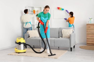 Kadın hademe odada süpürge temizleme halısı