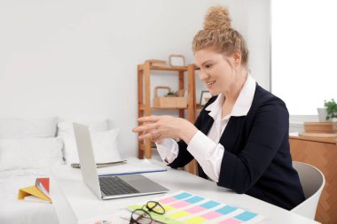 Evde dizüstü bilgisayarı olan genç ve güzel bir kadın sohbet ediyor. Serbest konsept