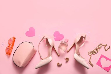 Composition with stylish female shoes, accessories and hearts on pink background. Valentine's Day celebration