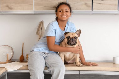 Mutfakta Fransız bulldog 'u olan tatlı Afro-Amerikalı kız.