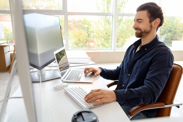 Male programmer at workplace in office
