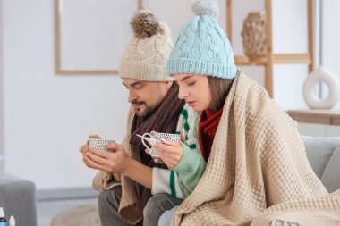 Sıcak çay ve evde ısıtma eksikliği olan hasta bir çift.