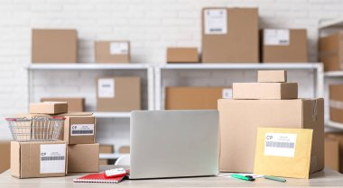 Posta deposundaki masada paketli dizüstü bilgisayar.