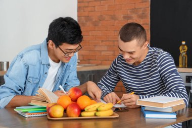 Yurt mutfağında okuyan erkek öğrenciler