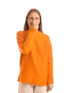 Young woman feeling disgusting smell on white background clipart