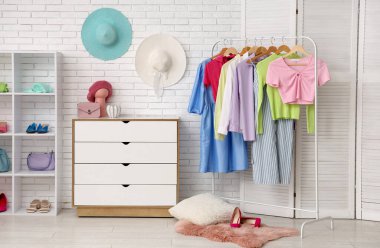 Askısı, çekmecesi ve raf ünitesi olan şık bir soyunma odası.