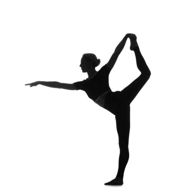 Beyaz arka planda yoga yapan genç bir kadının silueti.