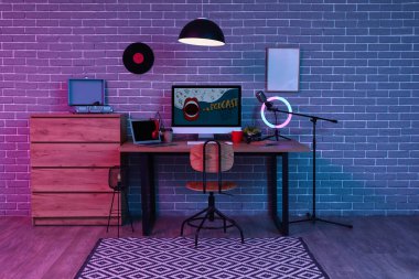 Podcaster 'ın iş yeri, tuvaleti ve parlayan lambası olan karanlık stüdyonun içi.