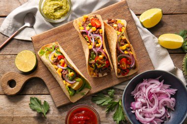 Taze takolu tepsi ve ahşap arka planda malzemeler.