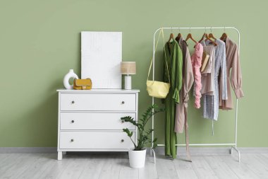 Soyunma odasının içinde şık çantalar, tuvalet ve elbise rafları var.