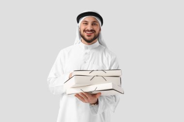 Arab businessman with folders on light background clipart