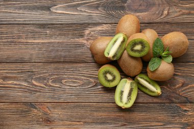 Bir sürü taze kivi ve ahşap zemin üzerinde nane.