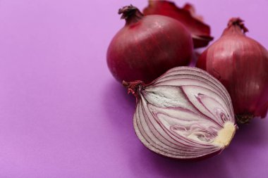 Mor arkaplanda taze kırmızı soğanlar