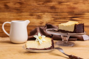 Tahta arka planda vanilyalı tatlı cheesecake ile cam tabak