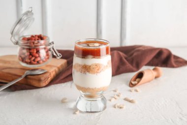 Beyaz duvarın yanındaki masada lezzetli fıstıklı cheesecake.