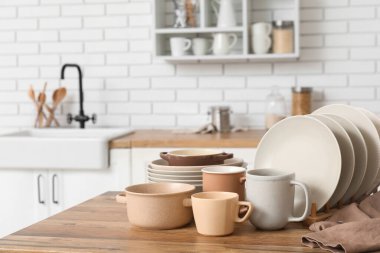 Mutfaktaki ahşap masada temiz tabaklar.