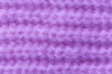 Arka plan olarak eflatun örülmüş kumaş dokusu, yakın plan