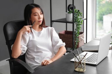 Kadın Asyalı İK uzmanı internetten adayla görüşüyor.