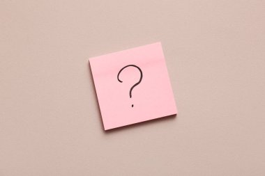 Renk arkaplanında soru işareti olan yapışkan bir not