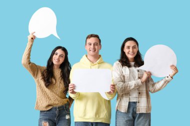 Mavi arka planda boş konuşma baloncukları olan gençler