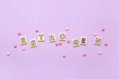 Mor arka planda hormonal haplar olan kelime ESTROGEN