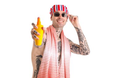 Tattooed man with sunscreen cream on white background clipart