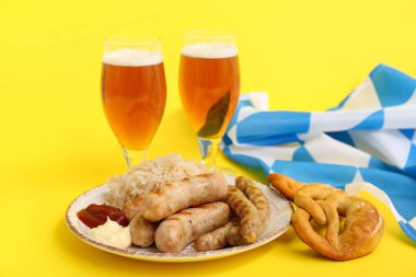 Glasses of cold beer with sausages, pretzel and flag of Bavaria on yellow background. Oktoberfest celebration clipart