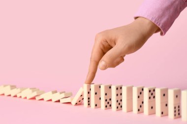 Pembe arka planda domino oynayan kadın, yakın plan.