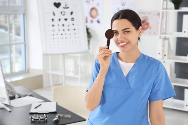 Female ophthalmologist with eye occluder in clinic clipart