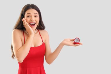 Arka planında nişan yüzüğü olan mutlu, sürpriz bir genç kadın. Sevgililer Günü kutlaması