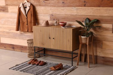 Koridorun içinde çekmeceler ve askıda ceketler var.