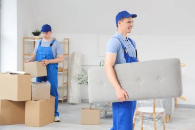 Yükleyiciler şık bir odada bank taşıyor.