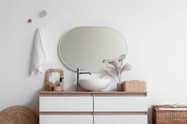 Lavabo, kutu ve banyo malzemeleriyle dolu sandık beyaz duvarın yanında, banyoda.