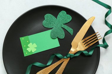 Beautiful table setting for St. Patrick's Day celebration on light background