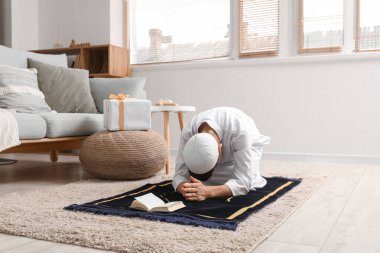 Little Muslim boy praying at home