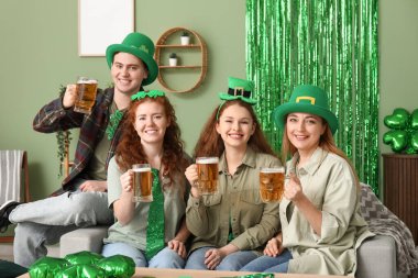 St. Patrick Günü 'nde evde oturan biralı bir grup insan.