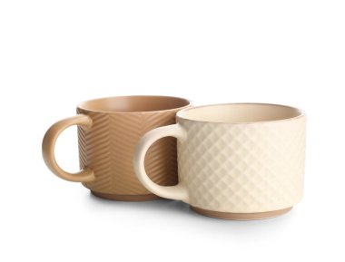 Beyaz arkaplanda farklı seramik bardaklar