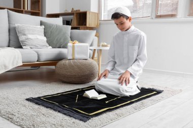 Little Muslim boy praying at home