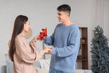 Evde lezzetli bir şarap kadehiyle mutlu bir çift.